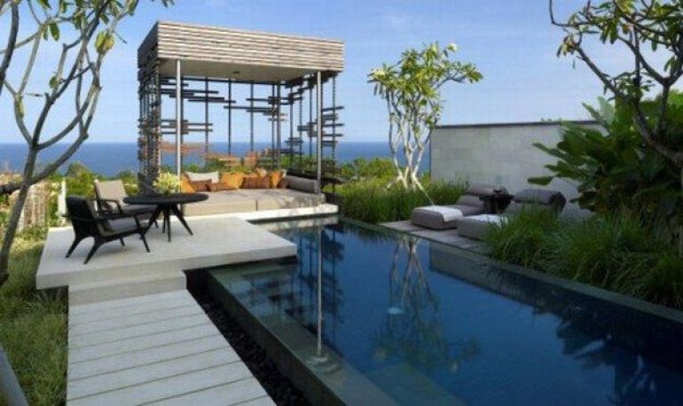 Pool with sun lounges and a private cabana overlooking the ocean