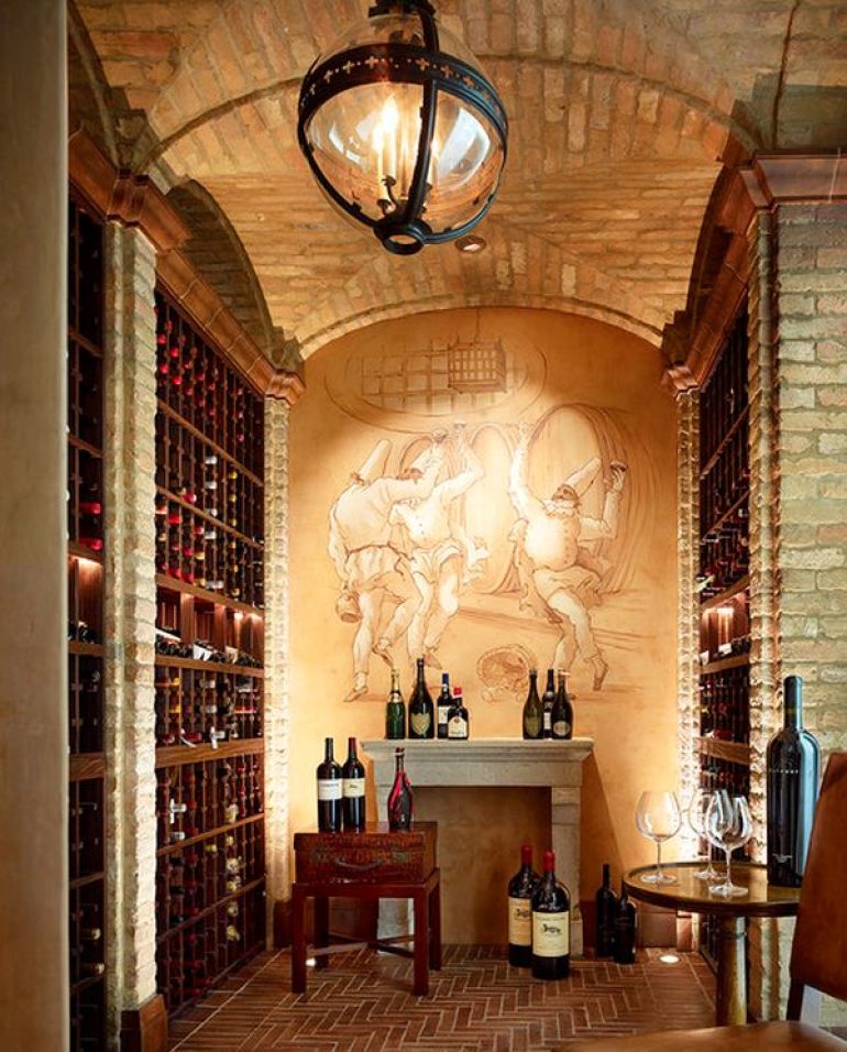 Wine cellar with seating and painting on wall